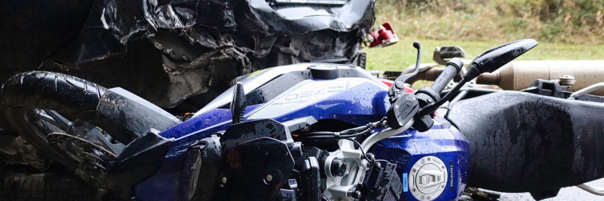 Image of a fallen damaged motorcycle after an accident